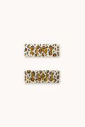 Plastic hair clips with animal print and 'TINY' logo on white background