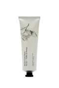 White tube of hand cream with black text and illustrations on a white background