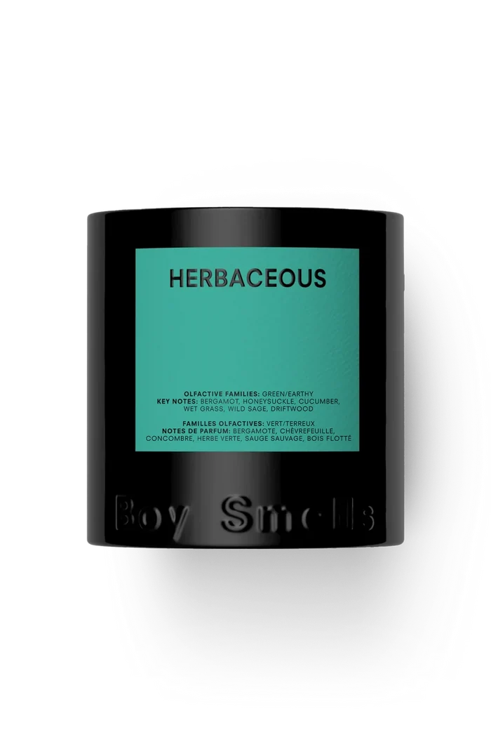 A matte black candle jar with a prominent teal-green label reading 'HERBACEOUS' and embossed 'Boy Smells' at the bottom, shown on a clean white background.