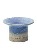 Ceramic candle holder with blue and beige speckled design on a white background
