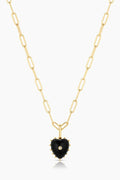 Gold necklace with a black heart-shaped pendant on a white background