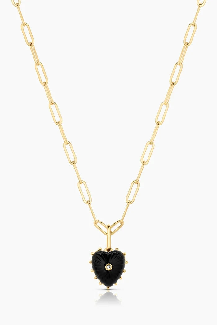 Gold necklace with a black heart-shaped pendant on a white background