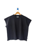 Dark grey t-shirt hung on a white wall