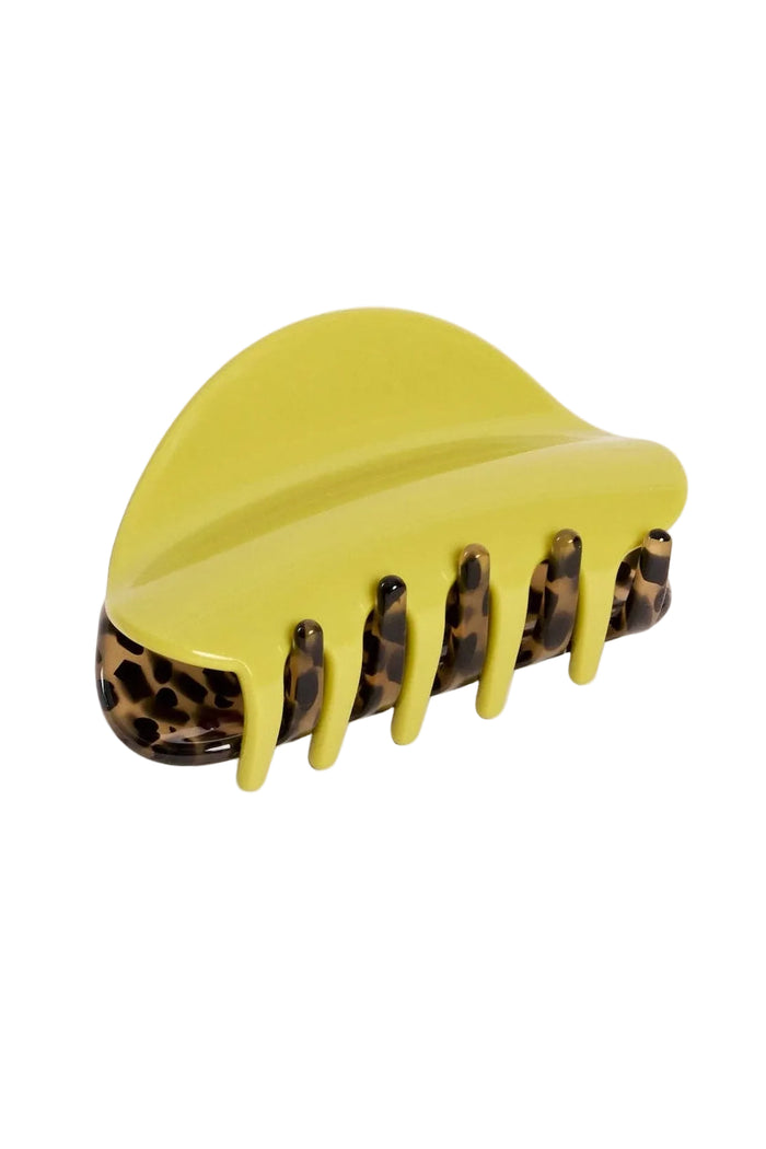 Yellow hair clip with leopard print accents on a light gray background