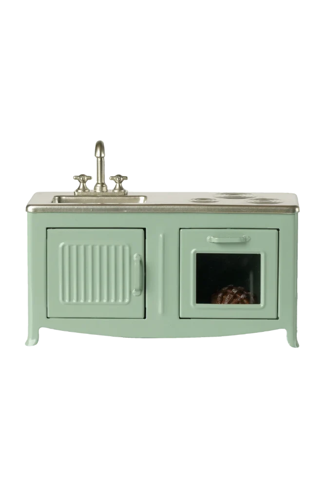 Mint green toy kitchen with sink and stove on a white background