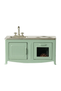 Mint green toy kitchen with sink and stove on a white background