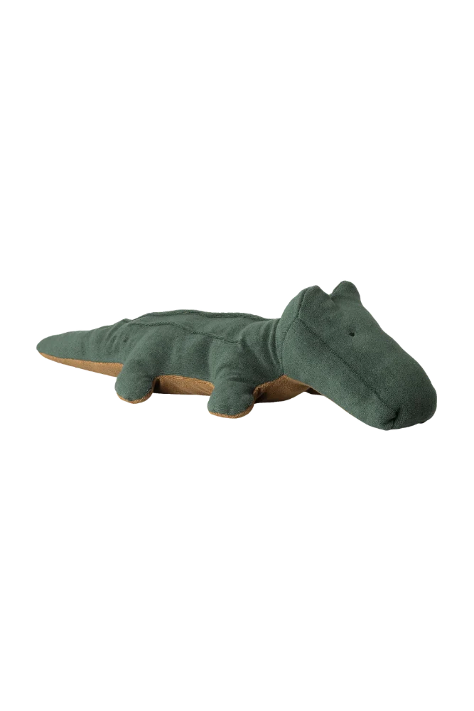 Green plush toy alligator on a white background