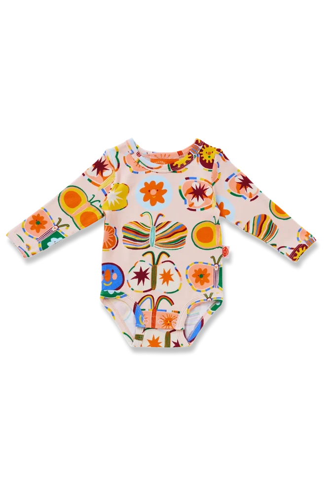 A long-sleeve baby bodysuit with a colorful, whimsical print featuring butterflies, flowers, and abstract shapes on a light pinkish-beige background, shown flat on a white background.