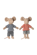 Two toy mice dressed in striped shirts and shorts on a white background