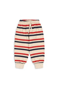A pair of children's striped jogger pants with horizontal navy, red, and cream stripes, featuring an elastic waistband with a drawstring and ribbed cuffs.