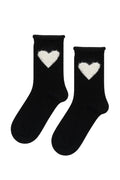 Black socks with white heart designs on a white background
