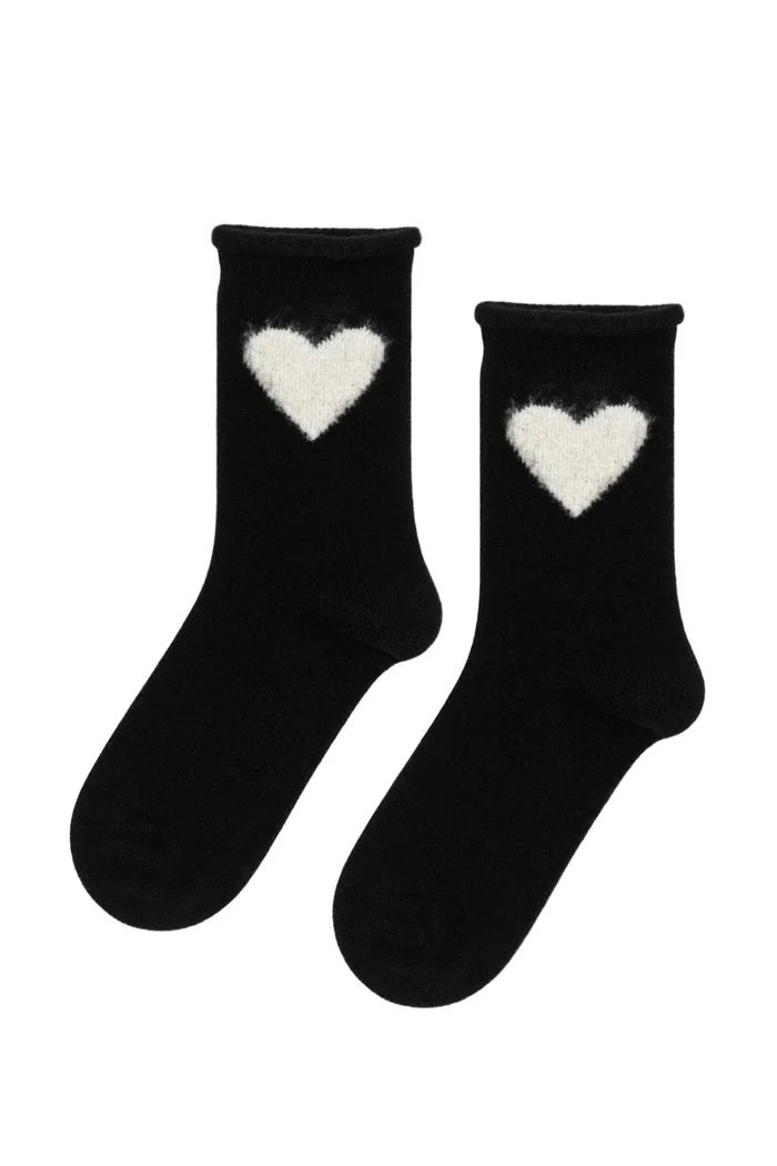 Black socks with white heart designs on a white background
