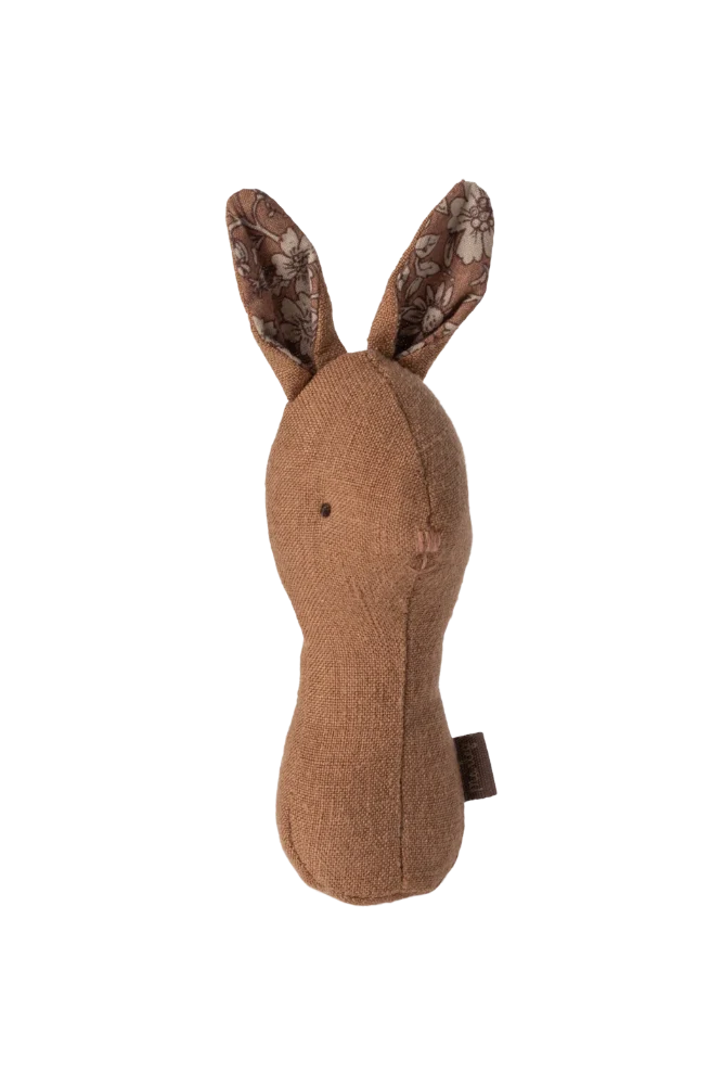 Brown fabric rabbit rattle on a white background