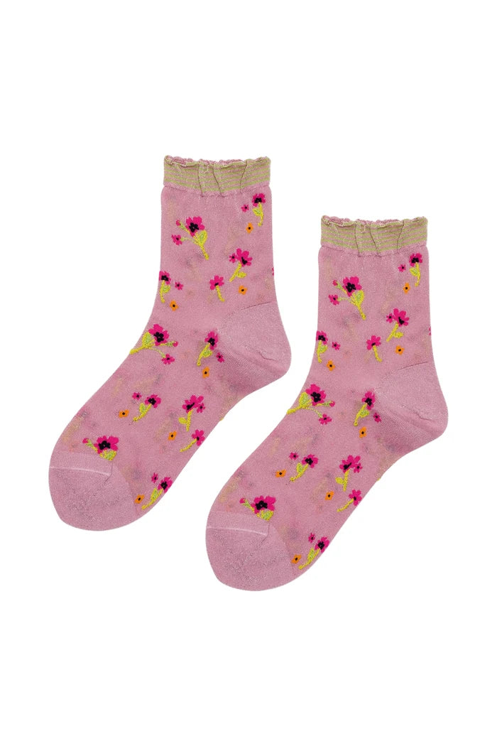 A pair of pink ankle socks with a small pink, yellow, and black floral pattern, featuring a ribbed beige cuff and toe.