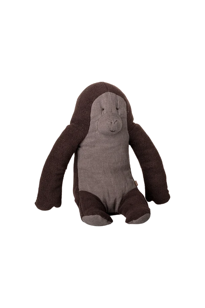 Stuffed toy gorilla with brown and gray linen on a white background