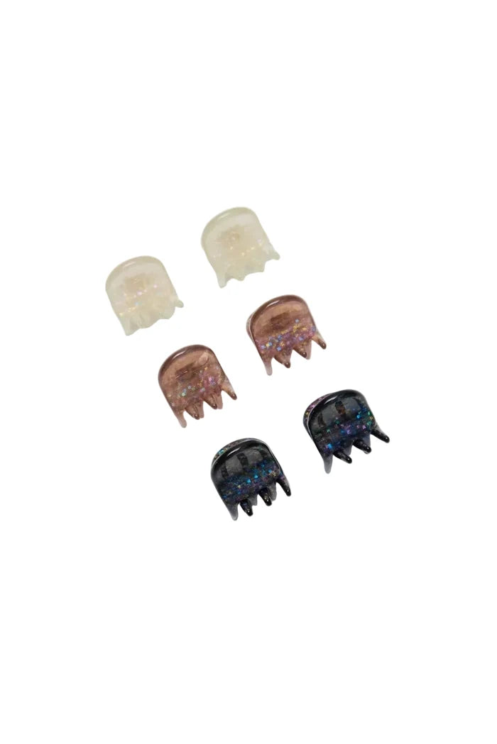 Set of six sparkly micro claw clips on white background