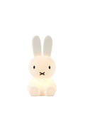 A Miffy-style bunny-shaped night light glowing with a warm white light, centered on a solid white background.