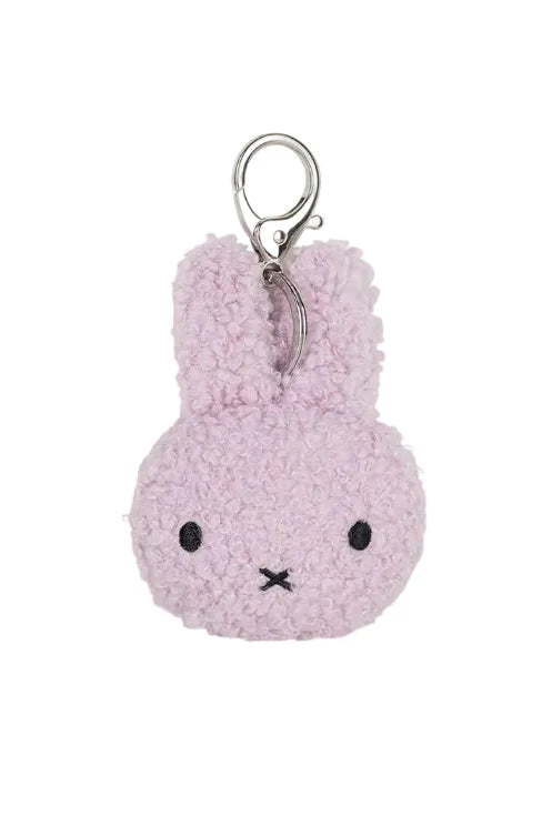 A light pink fuzzy plush bunny keychain with embroidered black eyes and mouth, attached to a silver metal key ring, shown on a plain white background.