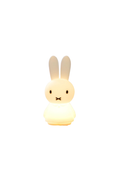 A small rabbit-shaped night light glowing with a warm yellow light, featuring long upright ears, simple black eyes, and a stitched mouth on a plain white background.