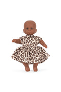 Doll wearing a leopard print dress on a white background