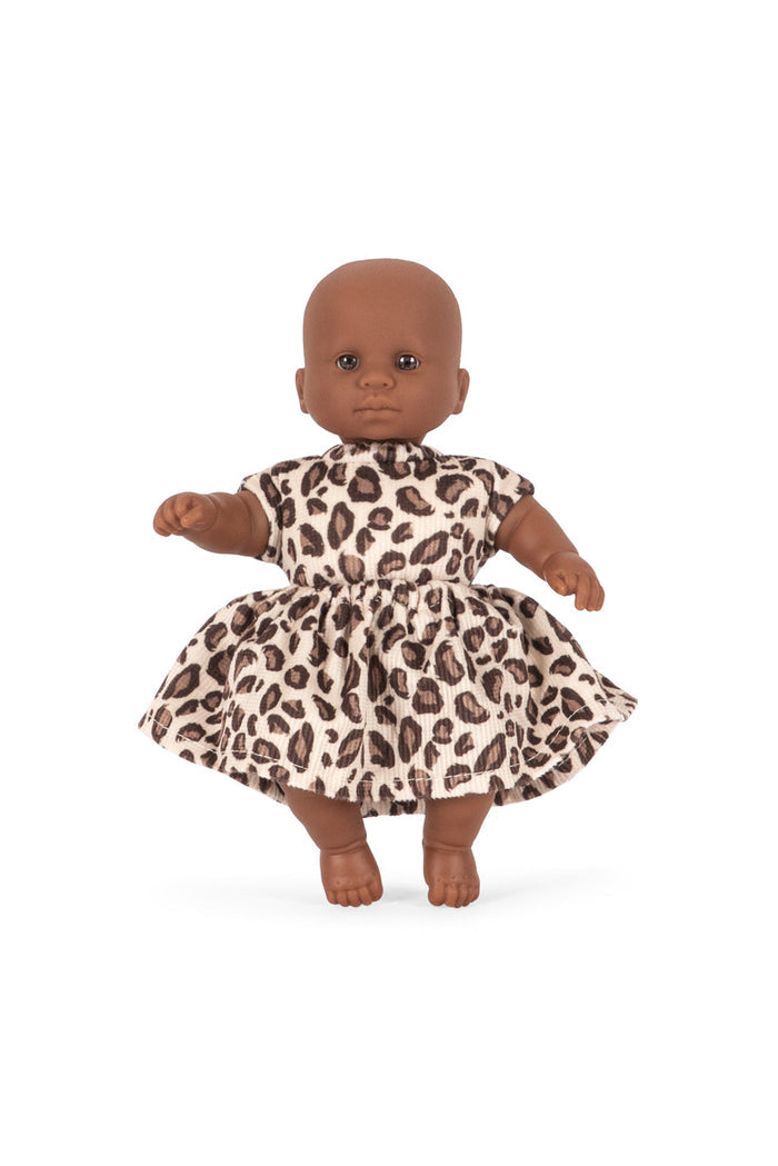 Doll wearing a leopard print dress on a white background