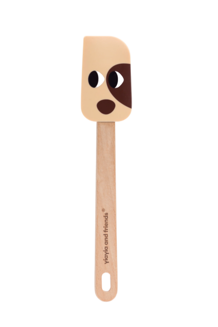 Spatula with dog face design on a white background
