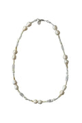 Pearl necklace with bead accents on white background