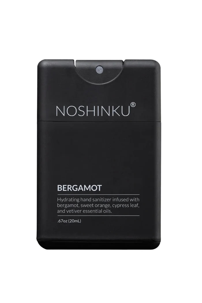 A black rectangular hand sanitizer dispenser bottle with a flip-top lid, labeled 'NOSHINKU BERGAMOT' in white text, on a clean white background.
