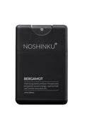 A black rectangular hand sanitizer dispenser bottle with a flip-top lid, labeled 'NOSHINKU BERGAMOT' in white text, on a clean white background.