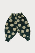 Green pants with mint polka dots on a white background