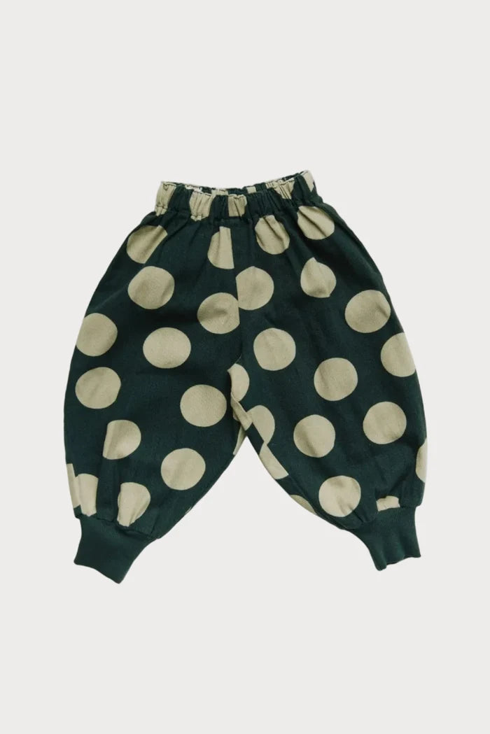 Green pants with mint polka dots on a white background