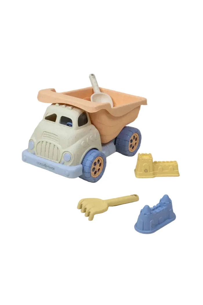 Plastic dump truck set with shovel, rake, and two sand castle molds on white background