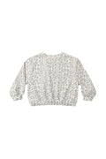 A long-sleeve crewneck sweatshirt featuring a gray leopard print pattern on a cream-colored background, laid flat against a light gray studio backdrop.