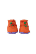 A pair of bright orange puffer boots with green drawstring loops and purple soles, shown against a plain white background.