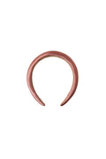 A padded headband with shiny mauve fabric on a white background