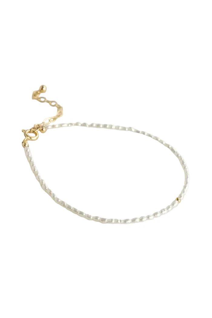 A delicate gold chain bracelet with a textured, beaded appearance and a lobster clasp, displayed on a clean white background.