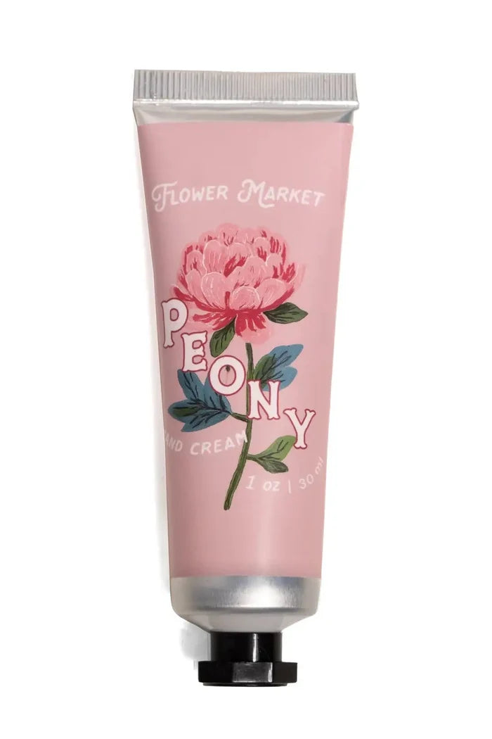Hand cream tube with pink packaging and floral design on a white background