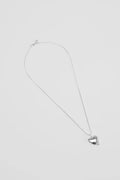 Silver necklace with a heart pendant on a light gray background
