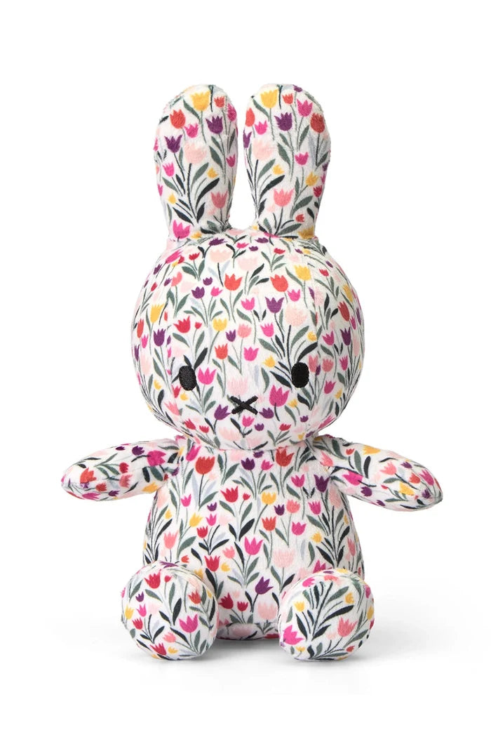 Stuffed toy rabbit with floral pattern on a white background