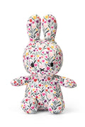 Stuffed toy rabbit with floral pattern on a white background