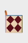 Quilted pot holder with diamond pattern on a light gray background