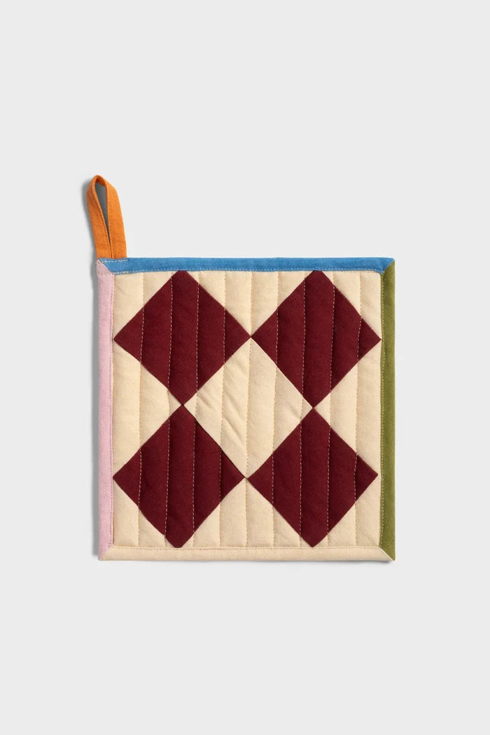 Quilted pot holder with diamond pattern on a light gray background
