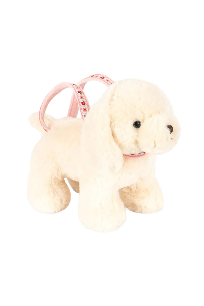 A cream-colored plush puppy purse with long floppy ears, black bead eyes set against a plain white background.