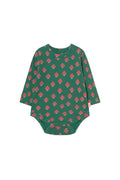 A long-sleeve baby bodysuit in dark green with a repeating pink mushroom pattern, laid flat against a light cream background.