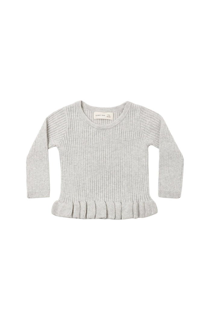 A light gray ribbed knit shirt with long sleeves and a ruffled hem, laid flat on a white background.