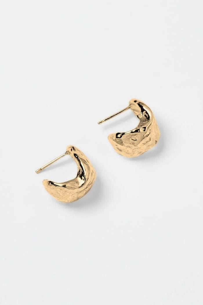 Gold hoop earrings on a white background