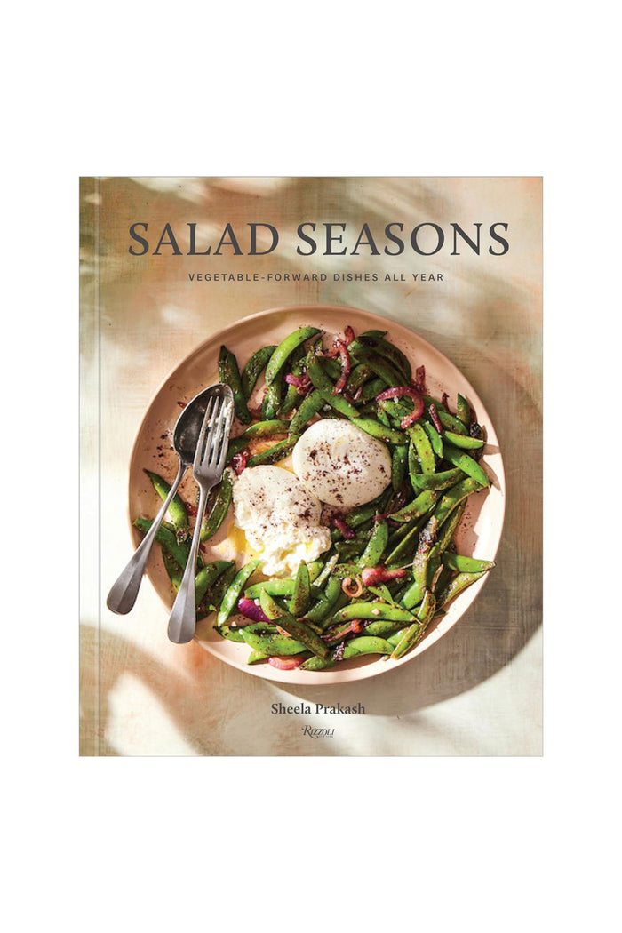 The cover of the cookbook titled 'Salad Seasons' featuring a bowl of salad with vegetables and cheese.