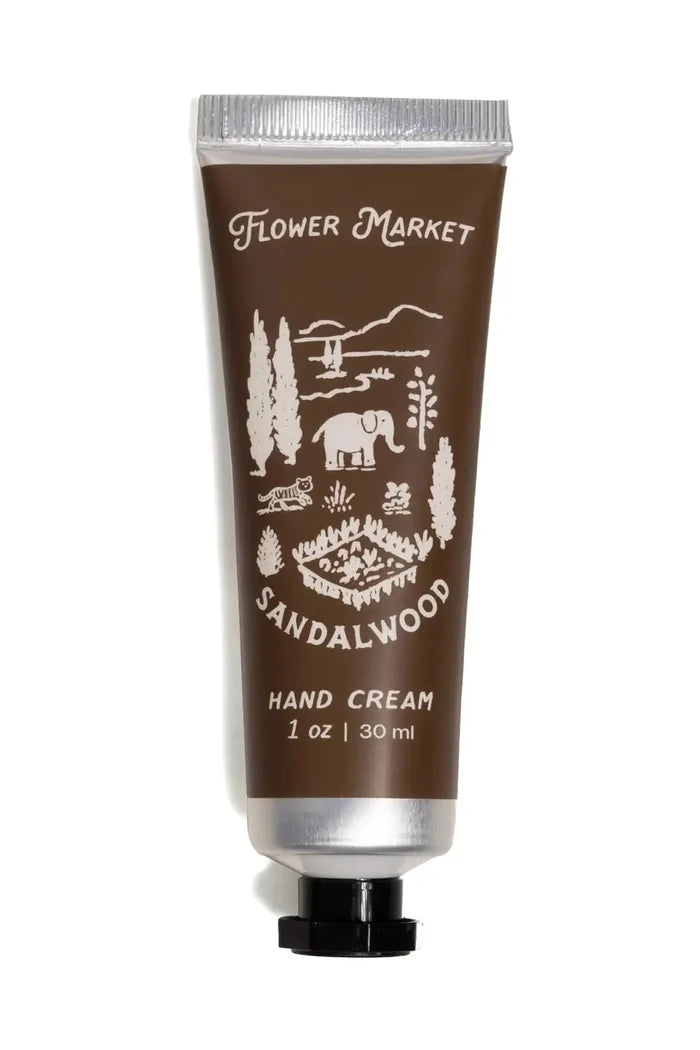 Hand cream tube labeled 'Flower Market Sandalwood' on a white background
