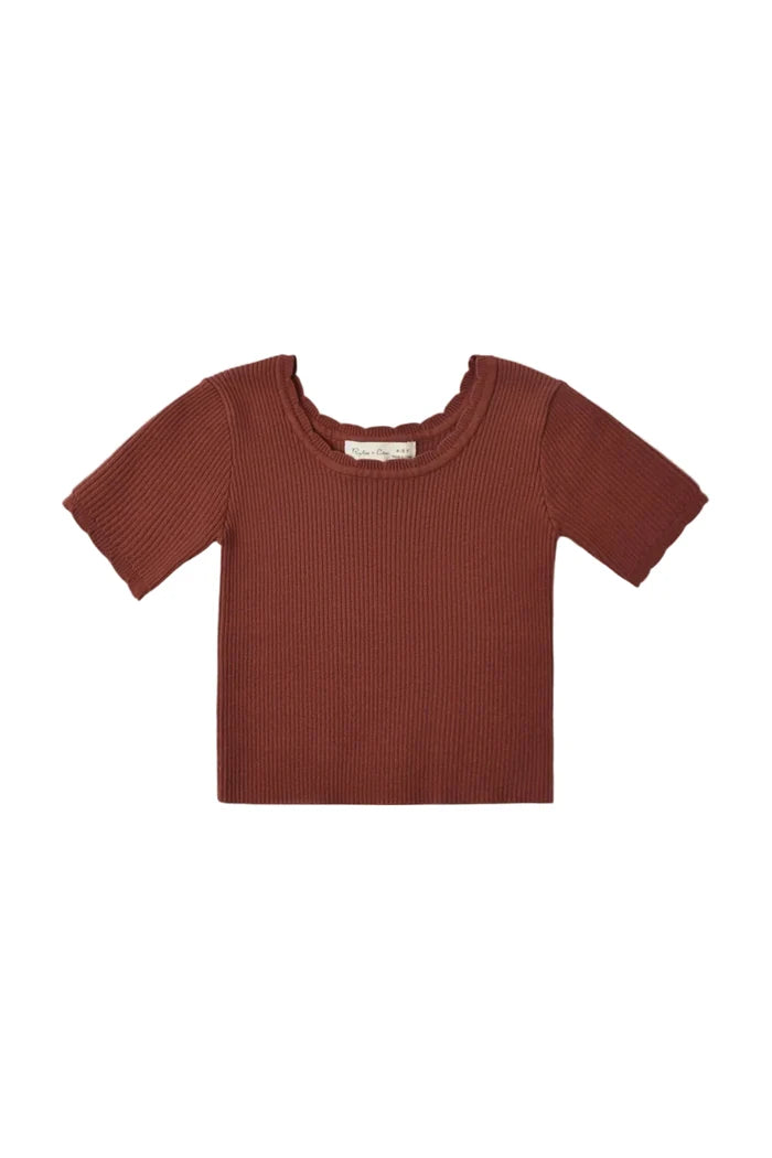A short-sleeve ribbed knit top in a muted terracotta or rust color, displayed flat against a solid off-white background.