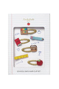 Box of school themed hair clips on white background